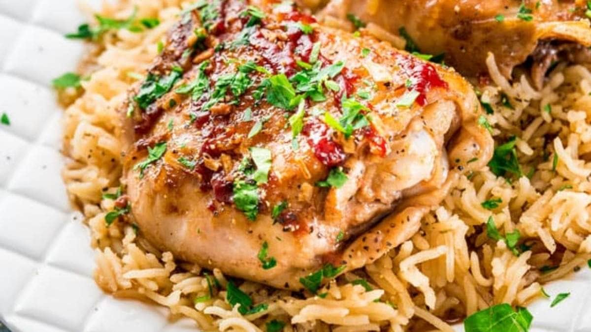 A plate with chicken and rice on it.