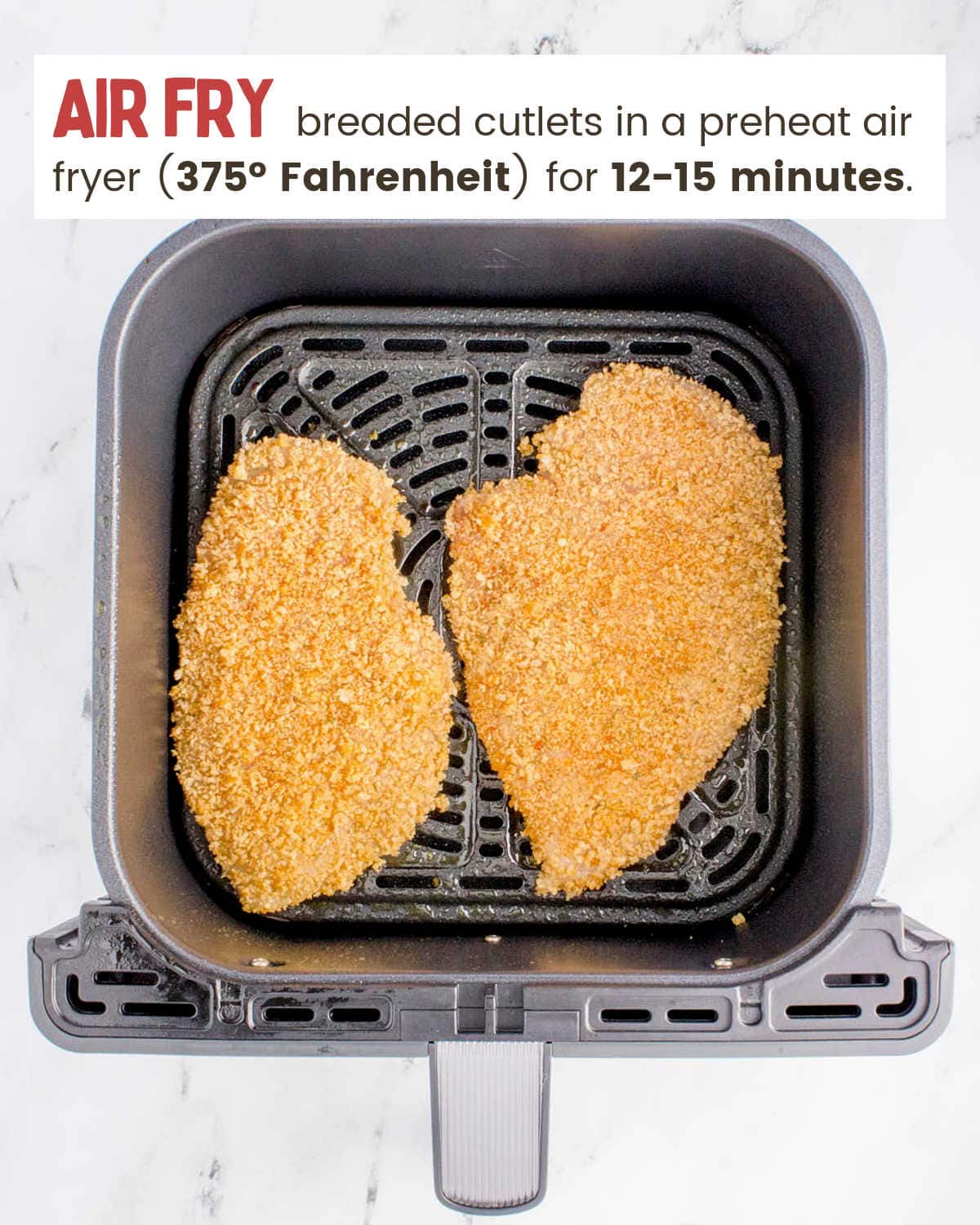 Two chicken cutlets cooked in an air fryer.