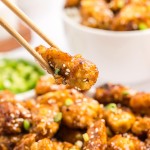 Honey Garlic Chicken served with chopsticks on a plate.