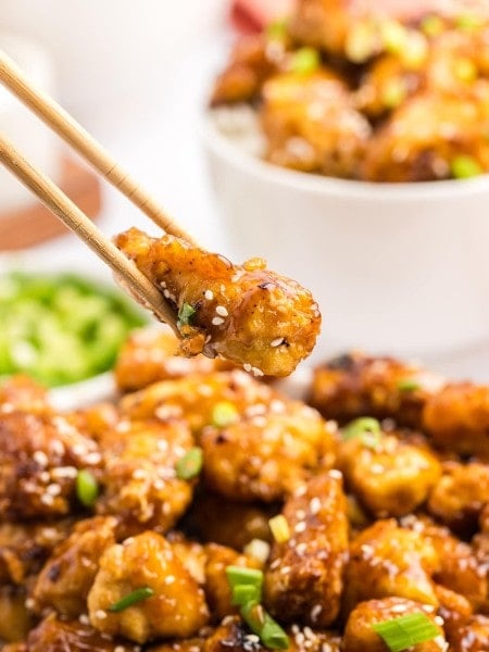 Honey Garlic Chicken served with chopsticks on a plate.
