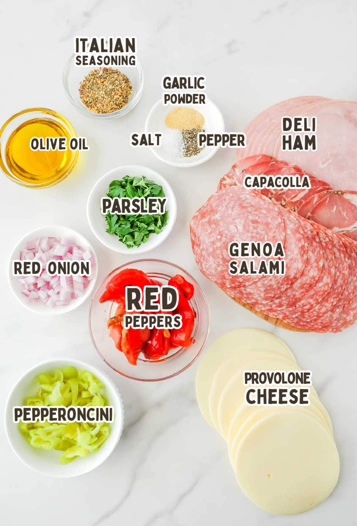 The ingredients for Italian Hoagie Dip on a marble countertop.