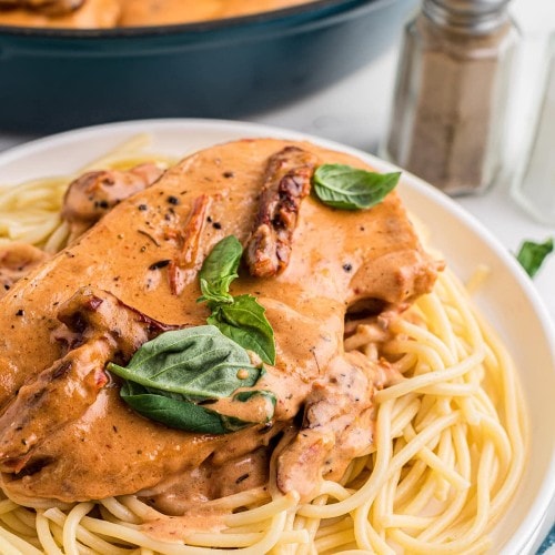 Marry Me Chicken recipe served on a white plate over pasta.