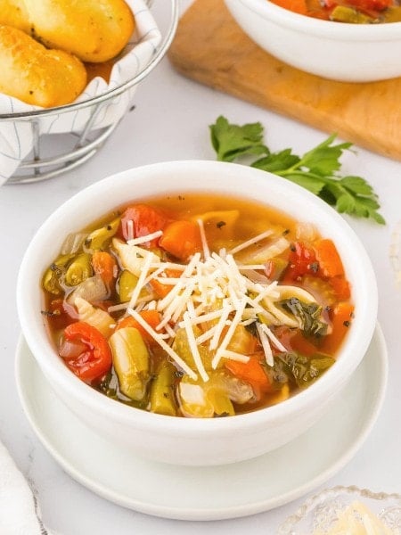 A Minestrone soup with bread on a table.