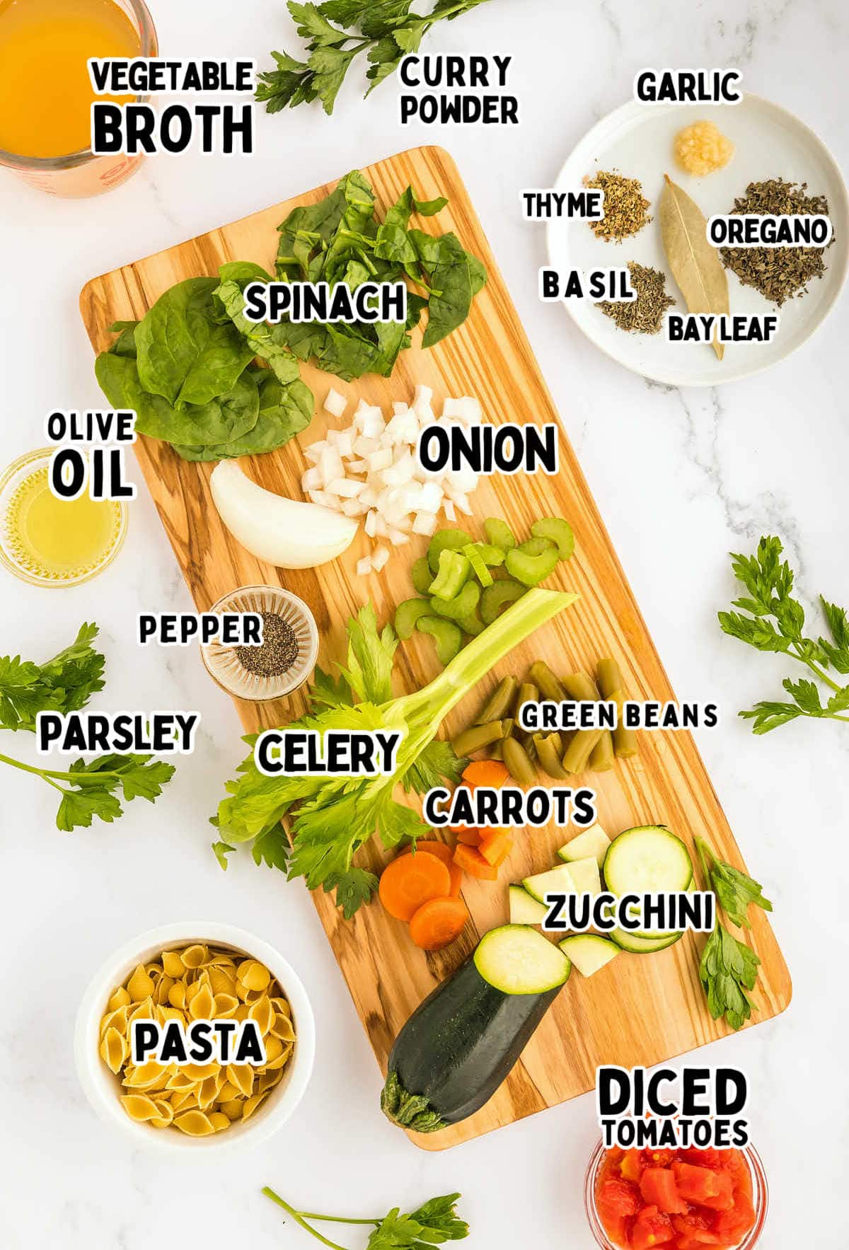 A cutting board with vegetables and pasta, for preparing Minestrone Soup.