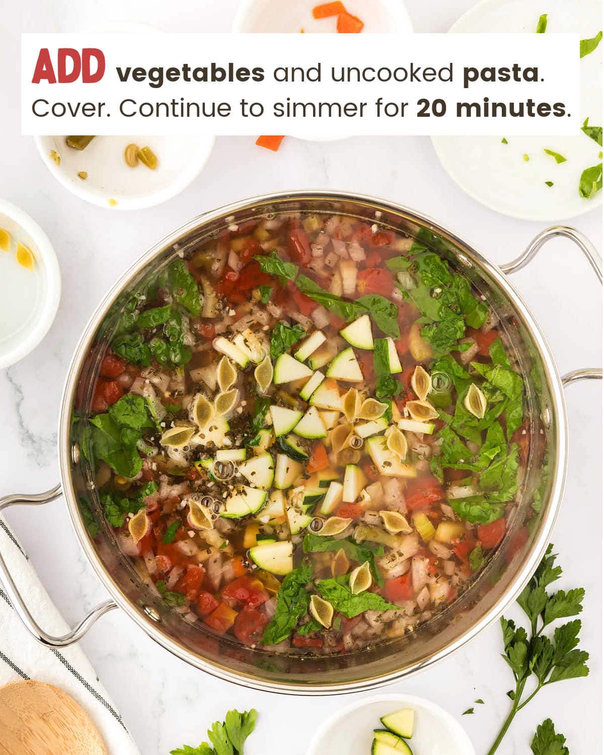 Adding vegetables and uncooked pasta to the Minestrone Soup.