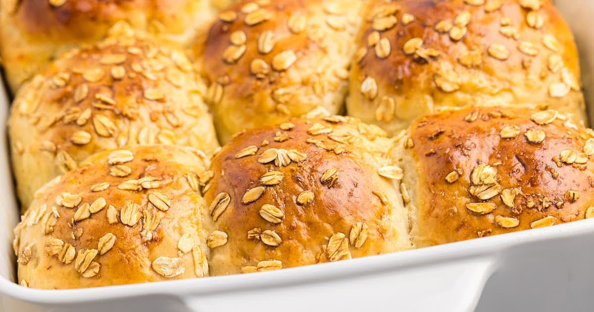 A baking dish filled with oatmeal rolls.