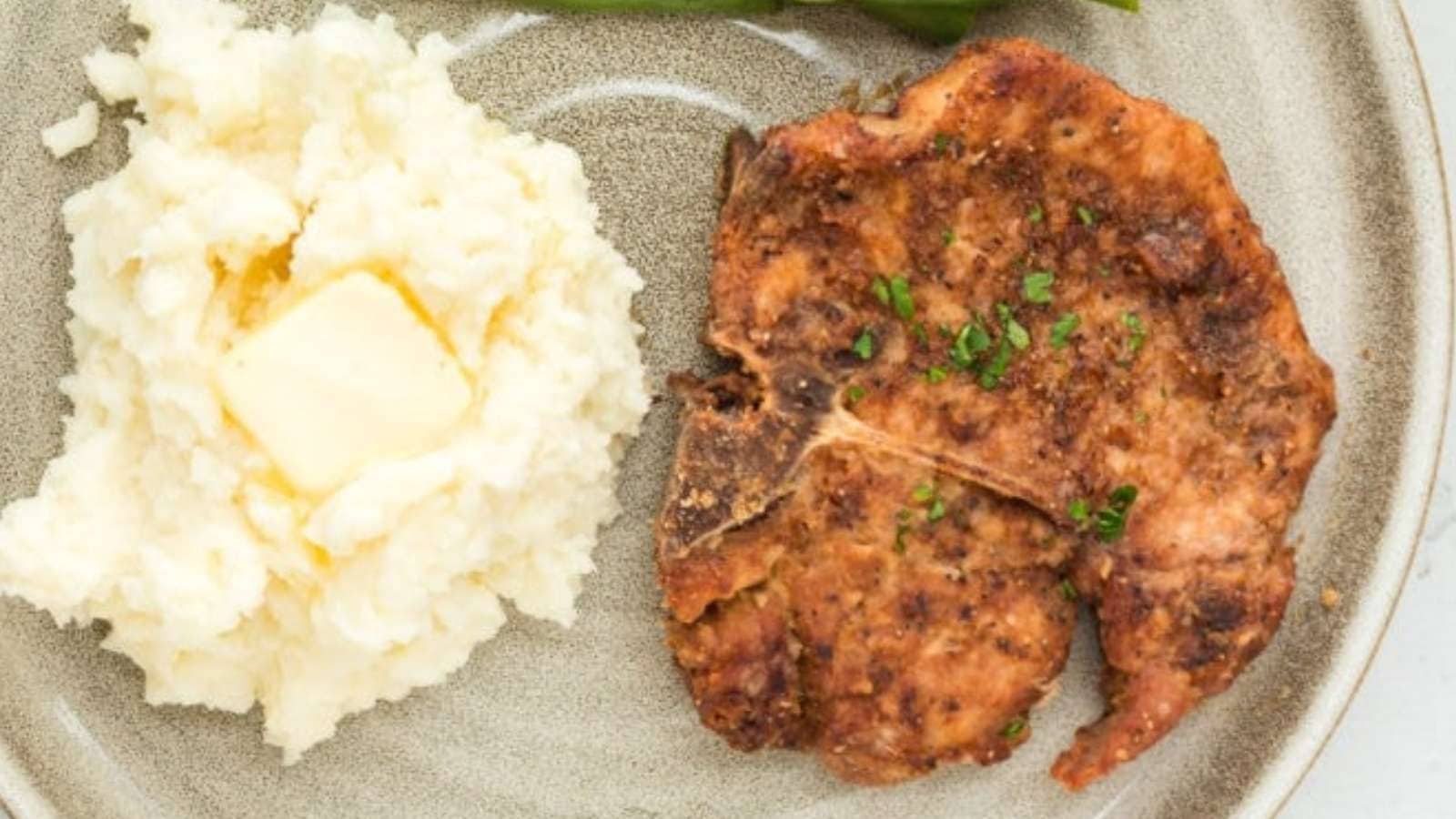 A plate of food with a fork and a knife.