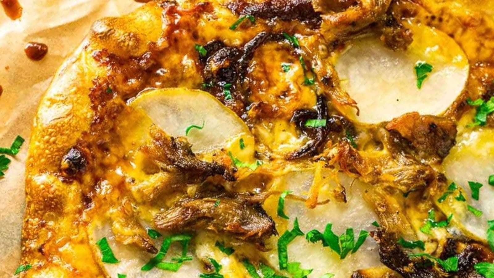 A close up of a pizza with onions and cheese.