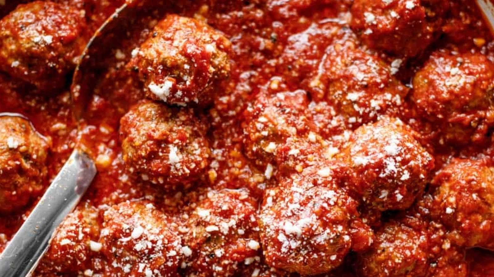 A bowl of meatballs covered in sauce.