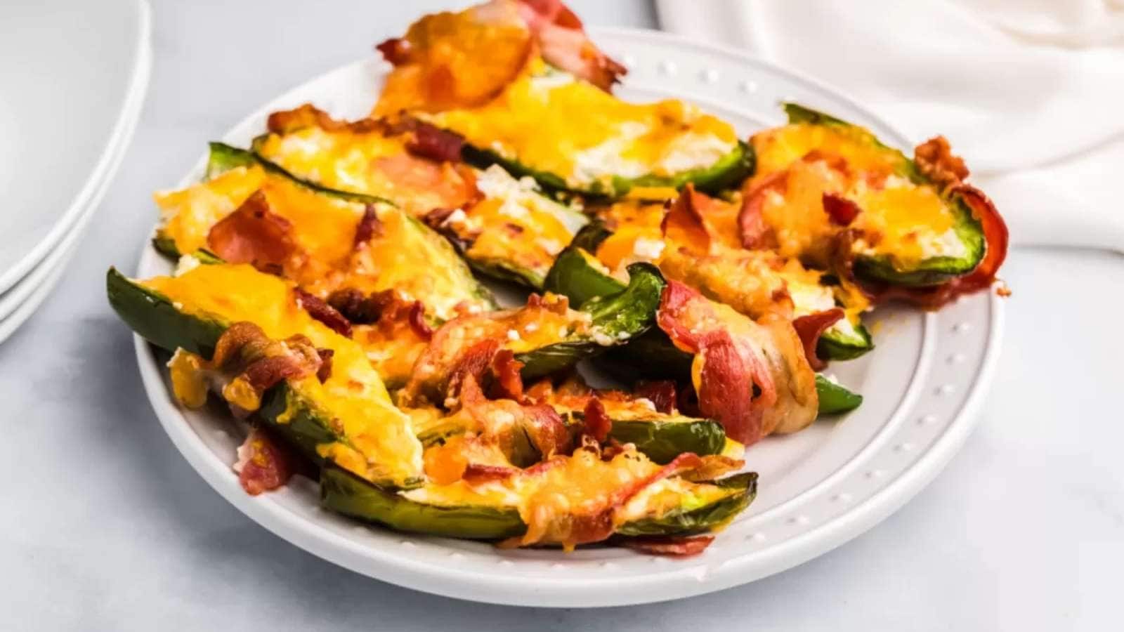 Stuffed jalapenos with bacon and cheese on a plate.