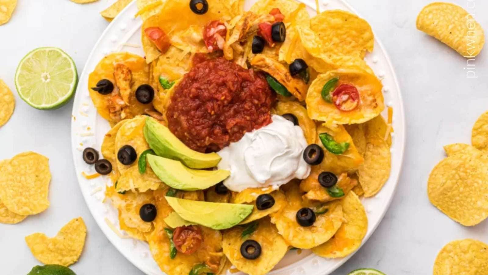 Mexican nachos with sour cream and avocado.