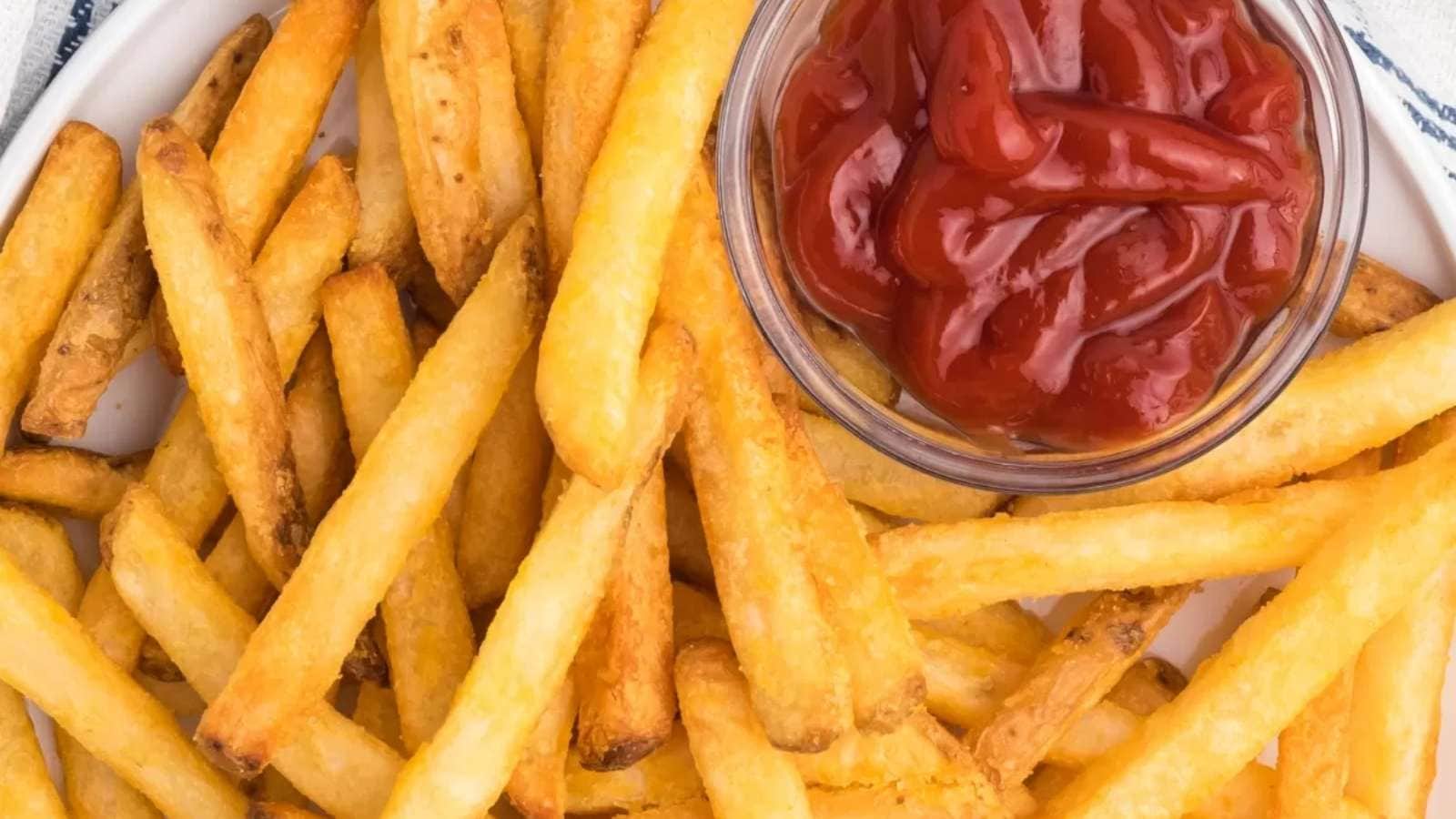 French fries with ketchup on a plate.