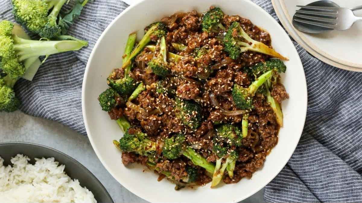 A bowl of beef and broccoli with rice.