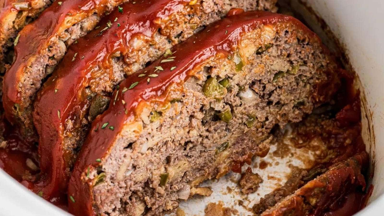 Meatloaf in a crock pot with ketchup.