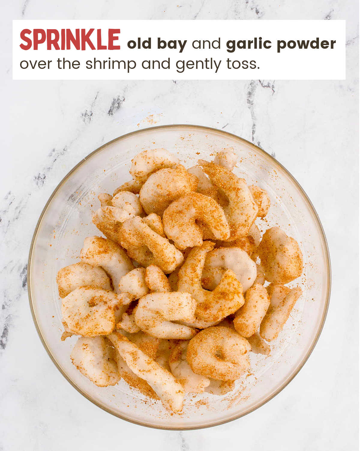 A bowl of shrimp with a sprinkle of old bay and garlic powder.