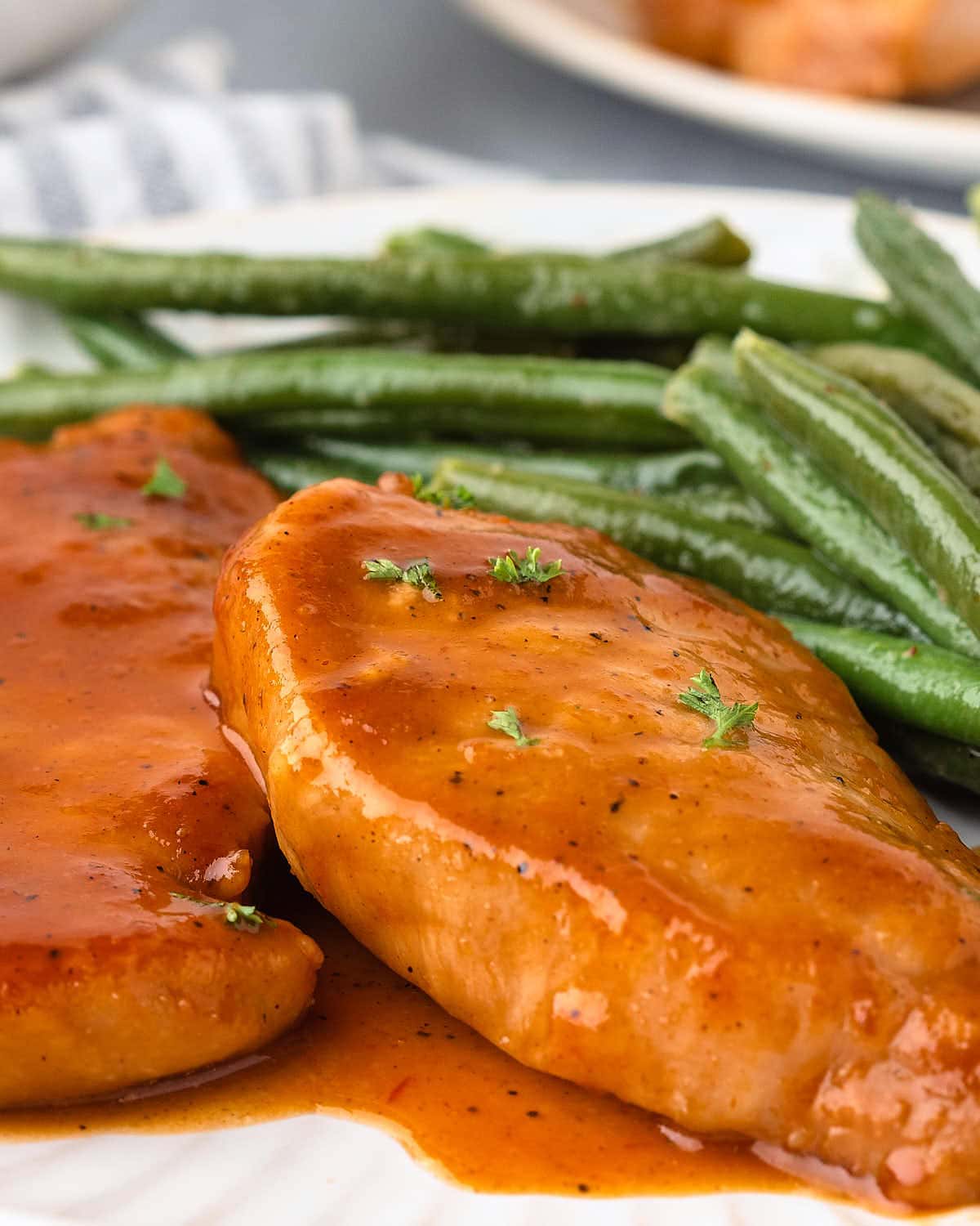 A plate with pork chops and green beans.