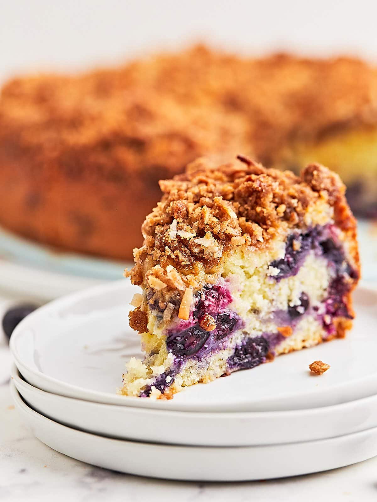 A slice of blueberry coffee cake on a plate.