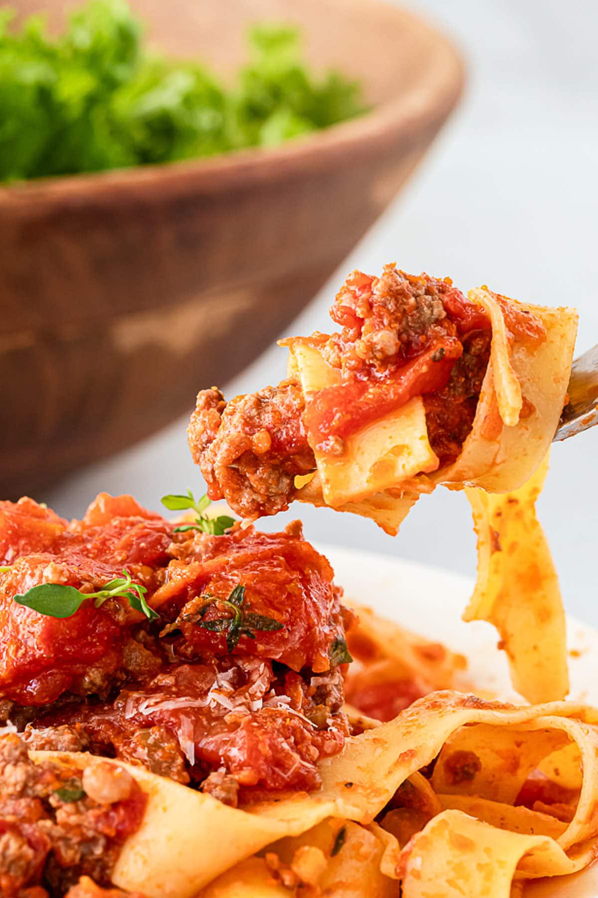 Tagliatelle with meat sauce and vegetables on a plate.