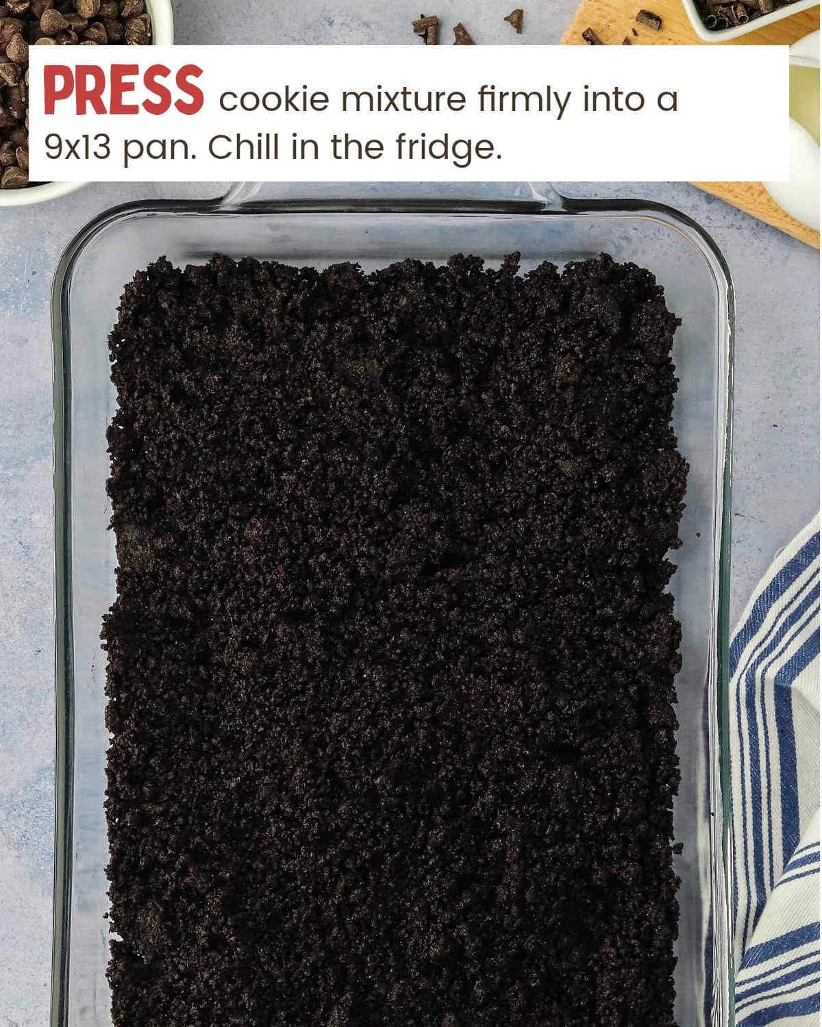 A baking dish with a cookie mix and chocolate chips, perfect for making Chocolate Lasagna.