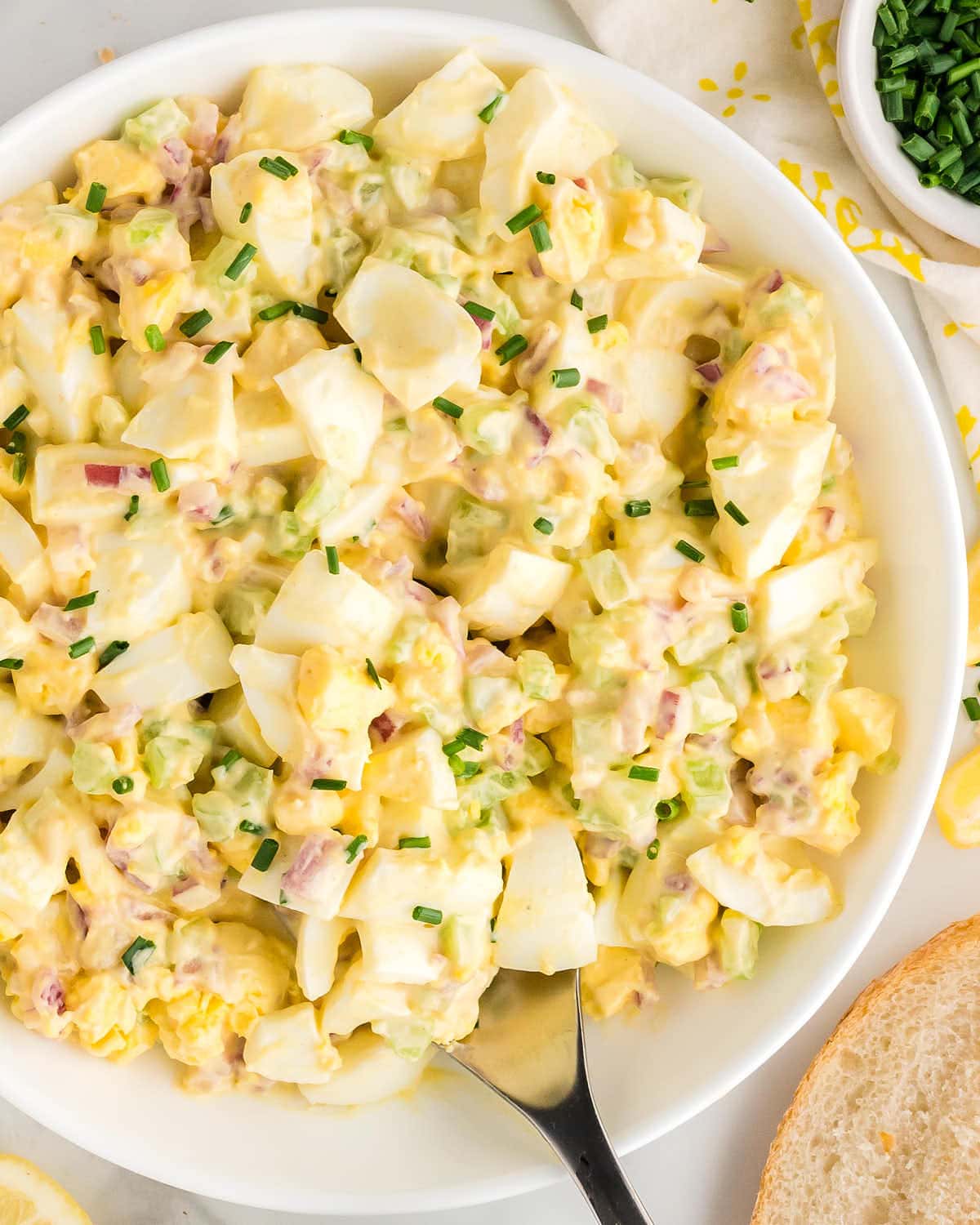 Egg salad served in a large white bowl.