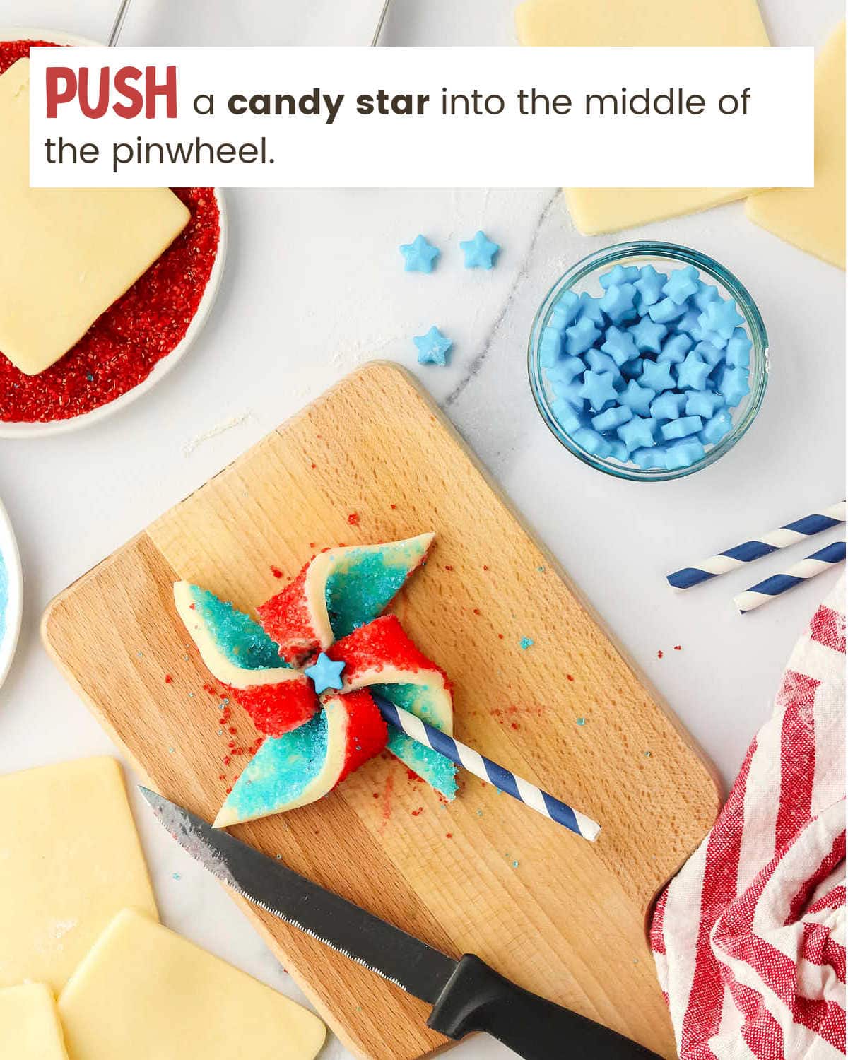 Finishing Fourth of July Pinwheel Cookies with candy star