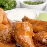 Air Fryer chicken wings served with carrots, celery, and dip.