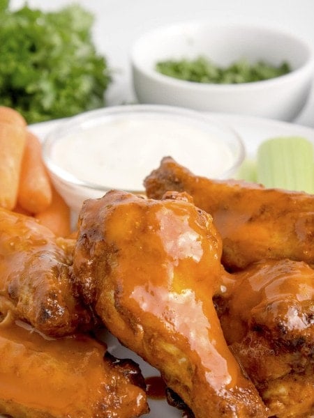 Air Fryer chicken wings served with carrots, celery, and dip.