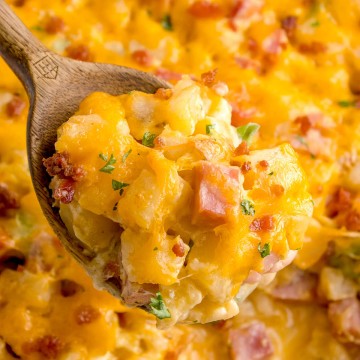 Ham and Potato Casserole with a wooden spoon.