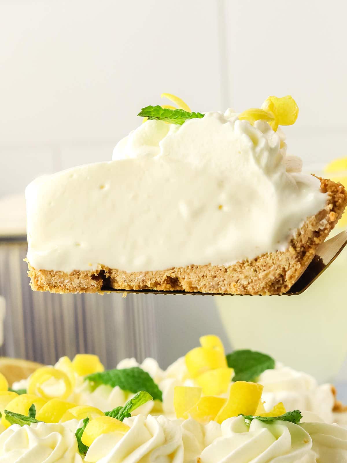 A slice of Lemonade Pie with whipped cream on top.