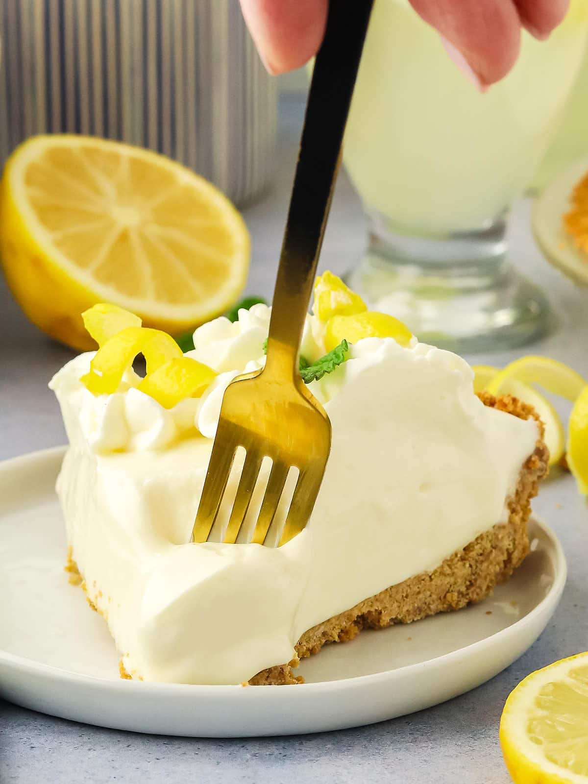 A slice of lemon pie with a fork.