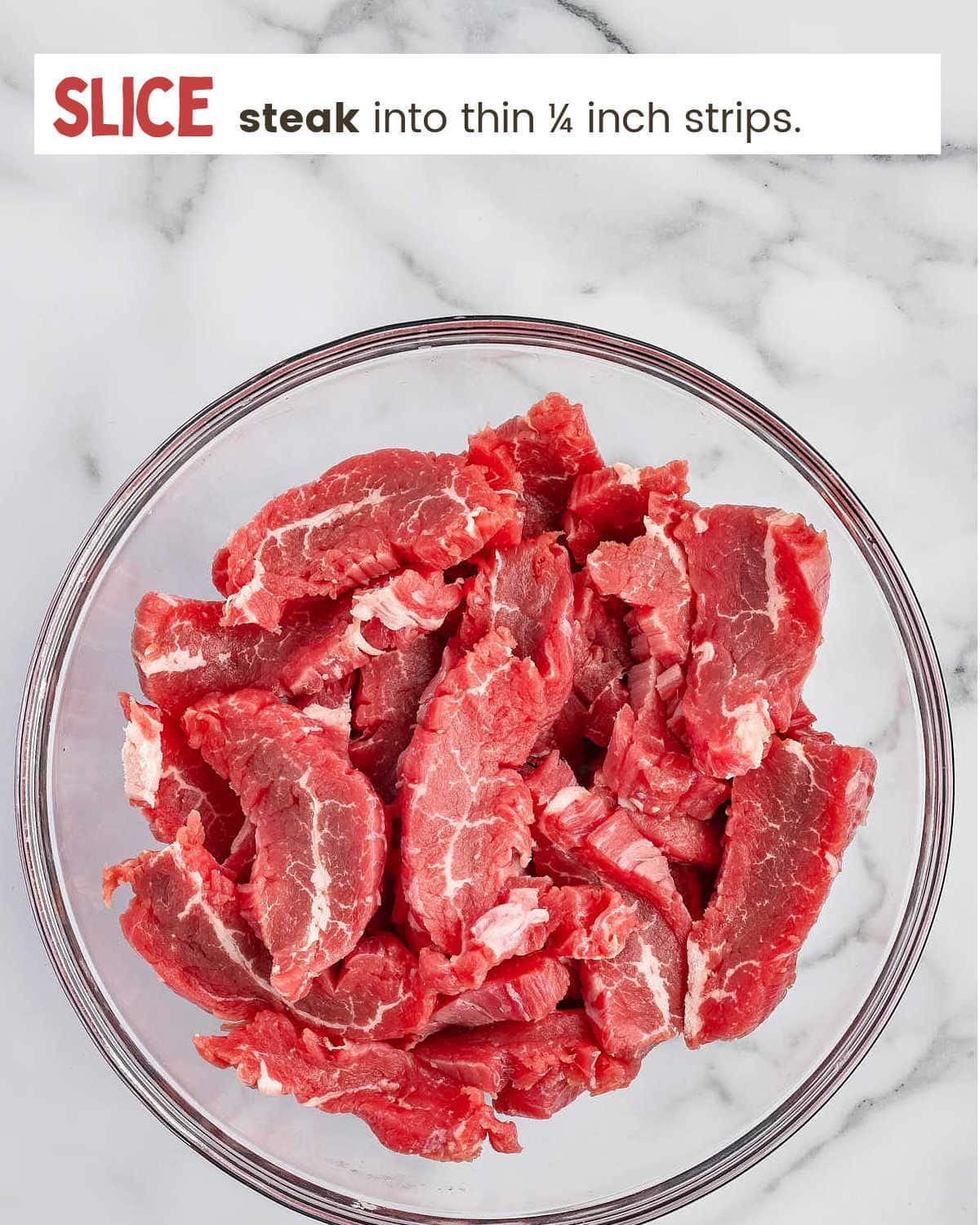Slices of flank steak in a bowl for Mongolian Beef
