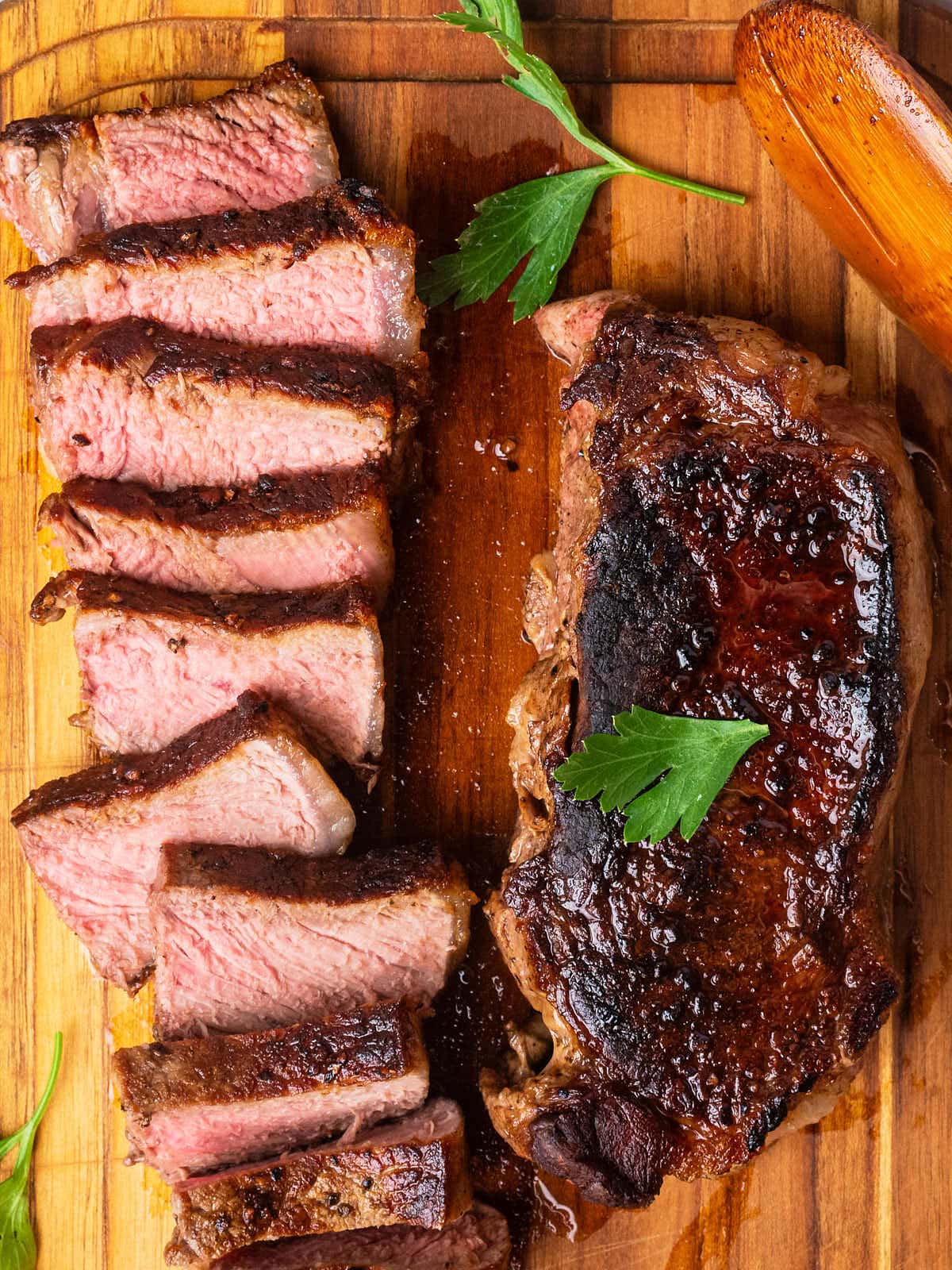 Delicious NY Strip Steak on a wooden cutting board.
