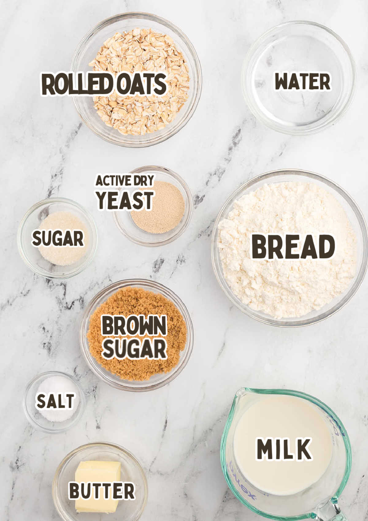 Oatmeal Dinner Rolls ingredients on a marble countertop.