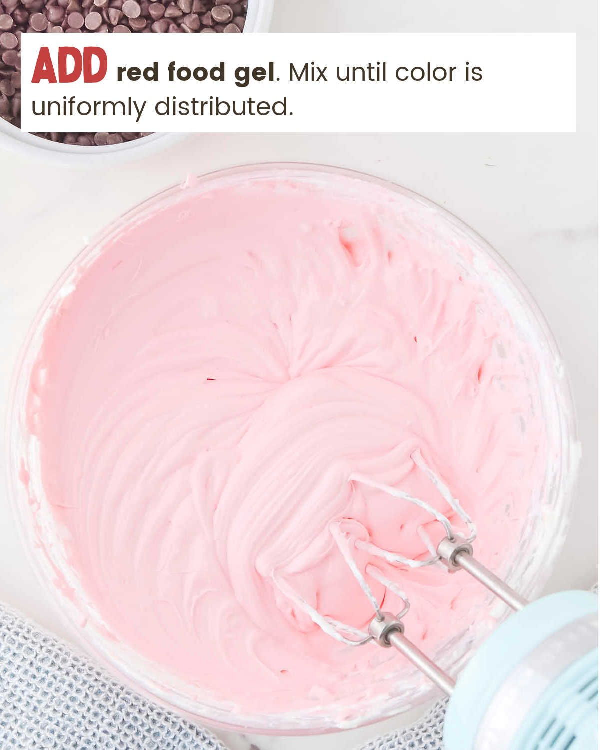 A mixing bowl containing a pink cream mixture for Pink Booty Dip