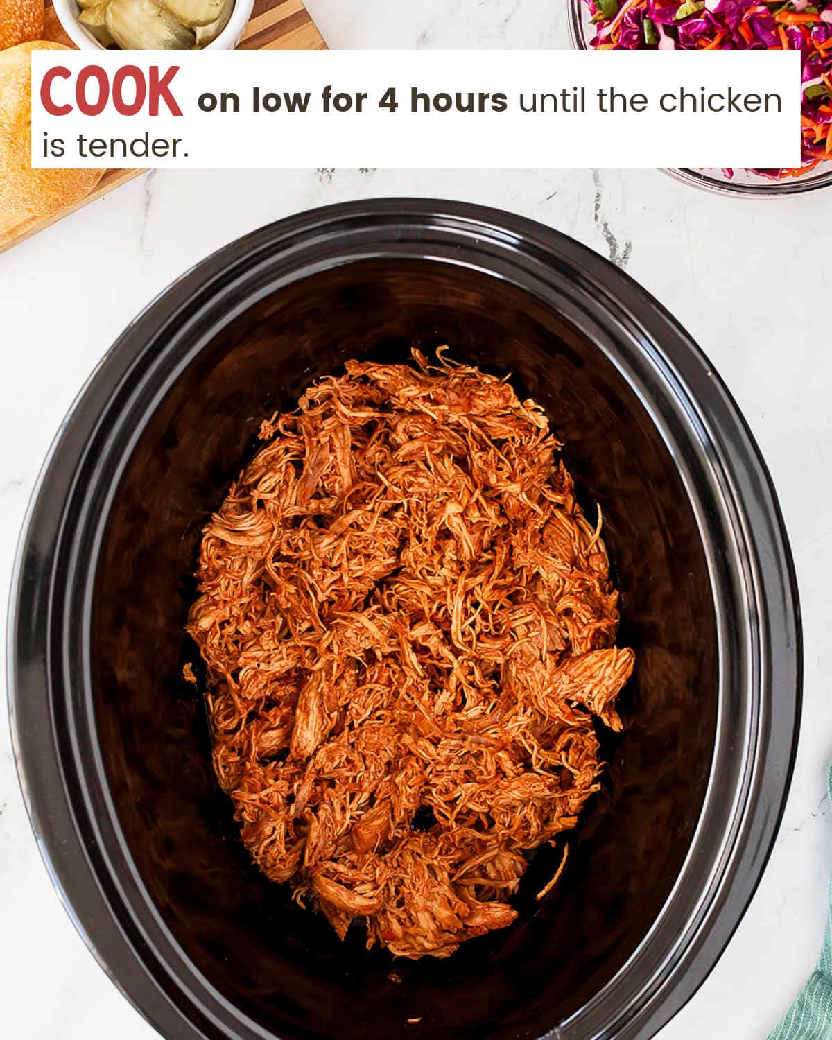 A slow cooker with a chicken in it, perfect for making tasty Slow Cooker Pulled Chicken or delicious Slow Cooker Pulled Chicken Sandwiches.