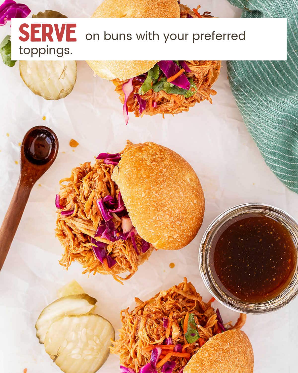 Serve Slow Cooker Pulled Chicken Sandwiches with your preferred toppings.