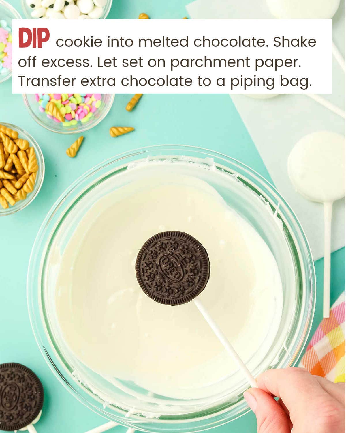 Dipping oreos in melted white chocolate for Unicorn Oreo Pops