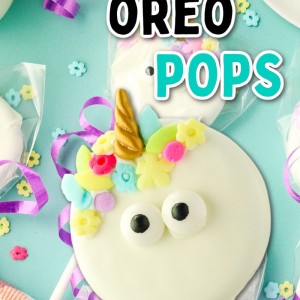 A white unicorn shaped cookie with a horn and flowers on it.