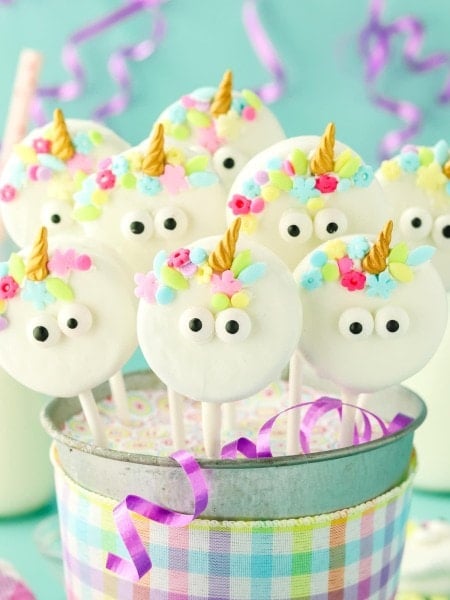 Unicorn Cake Pops in a decorated party bucket.