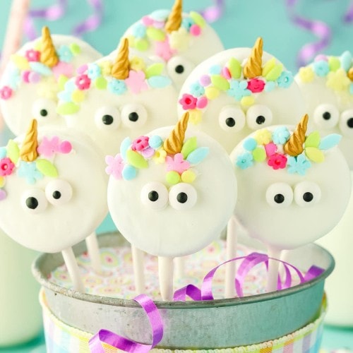 Unicorn Cake Pops in a decorated party bucket.