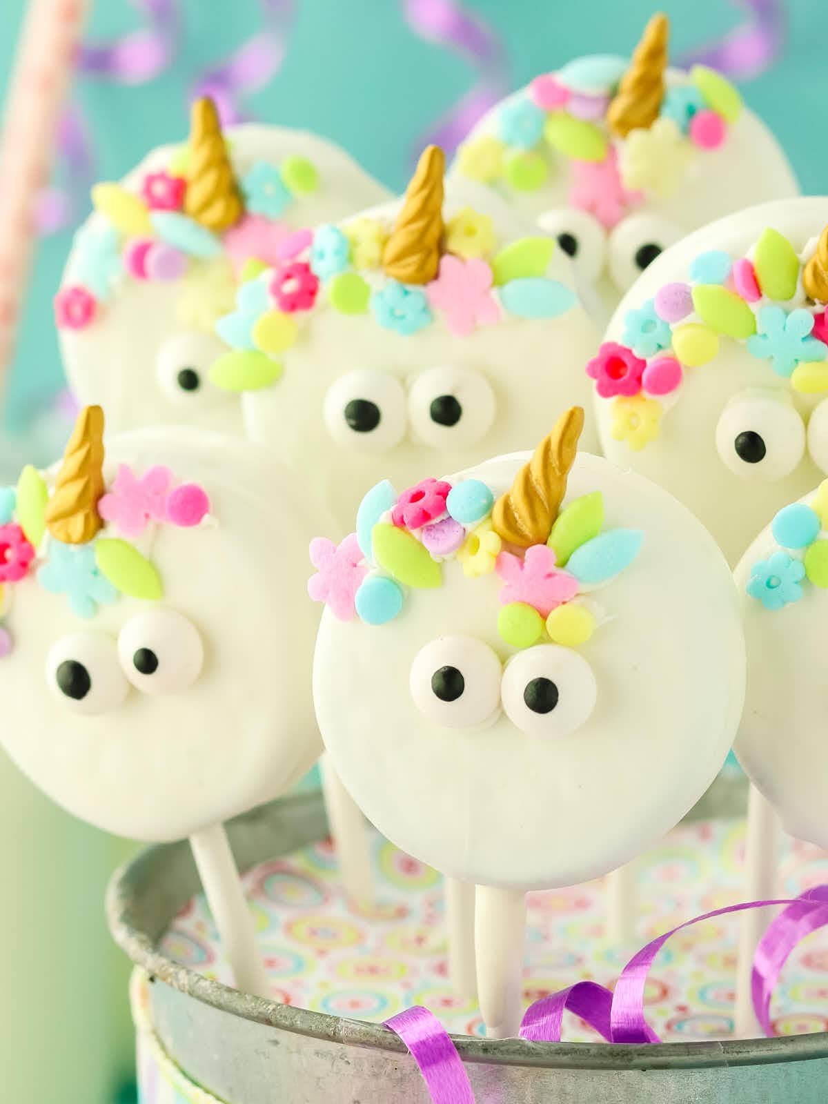 Unicorn cake pops in a bucket.