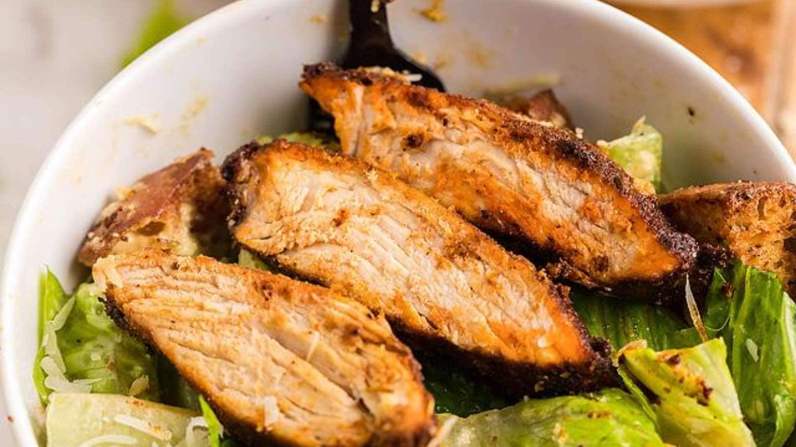 A bowl of food with a fork.