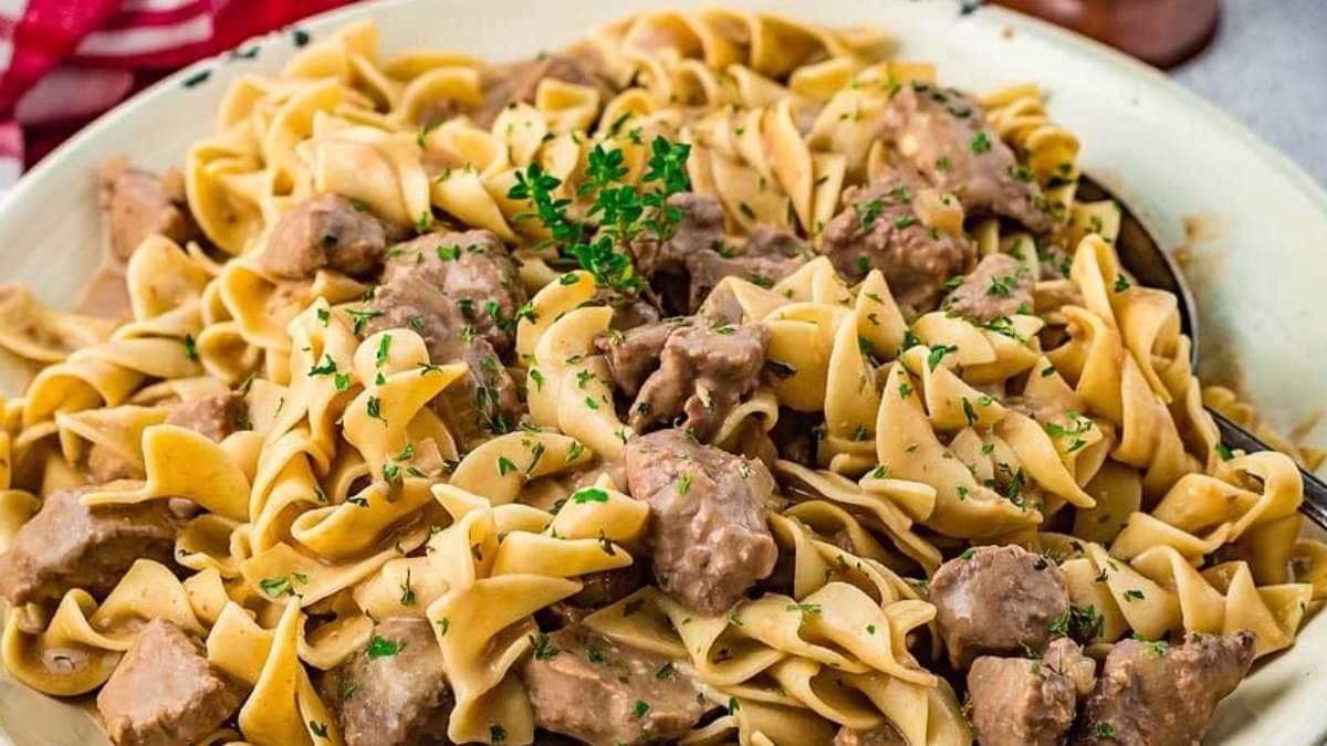 Swedish meatballs in a white bowl with parsley.