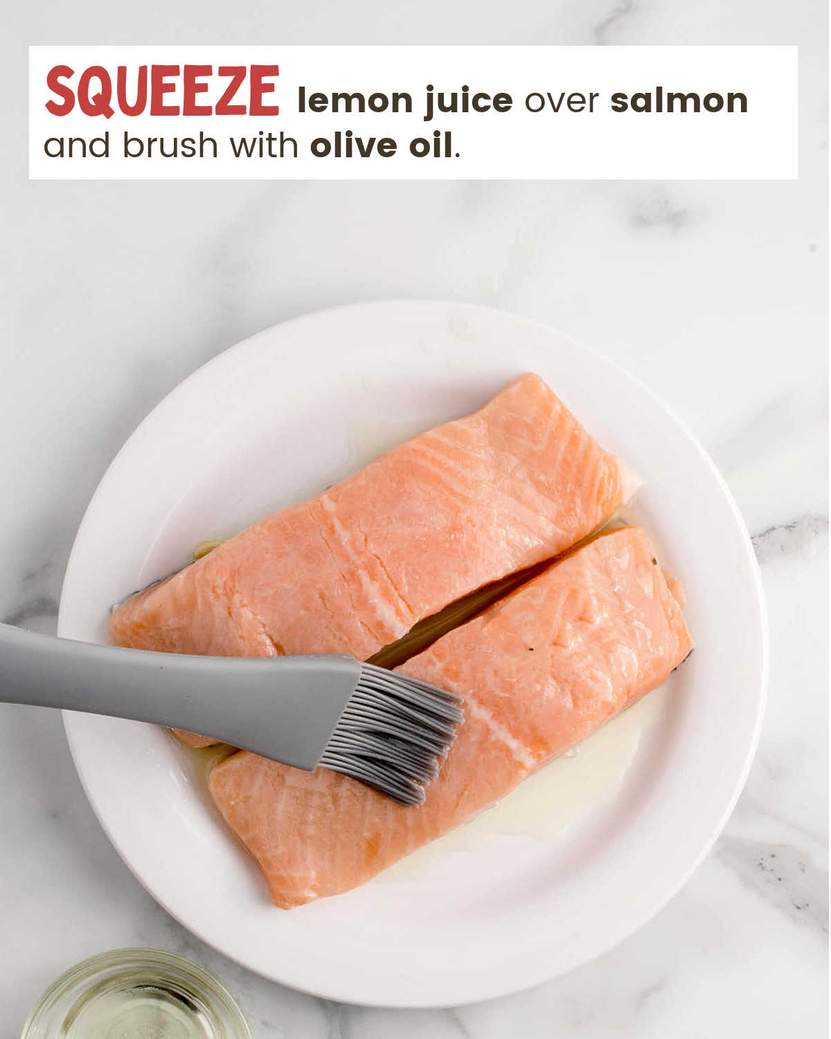 Brushing olive oil over fresh salmon filets.