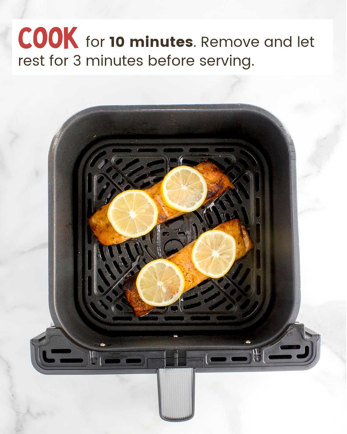 Cooked Air Fryer Salmon with lemon wedges.
