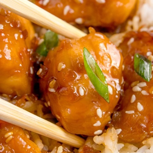 Closeup of Air Fryer Chicken Teriyaki served over rice picked up with chop sticks.
