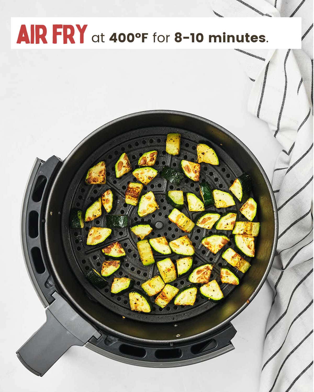Cooked Air Fryer Zucchini in air fryer basket.