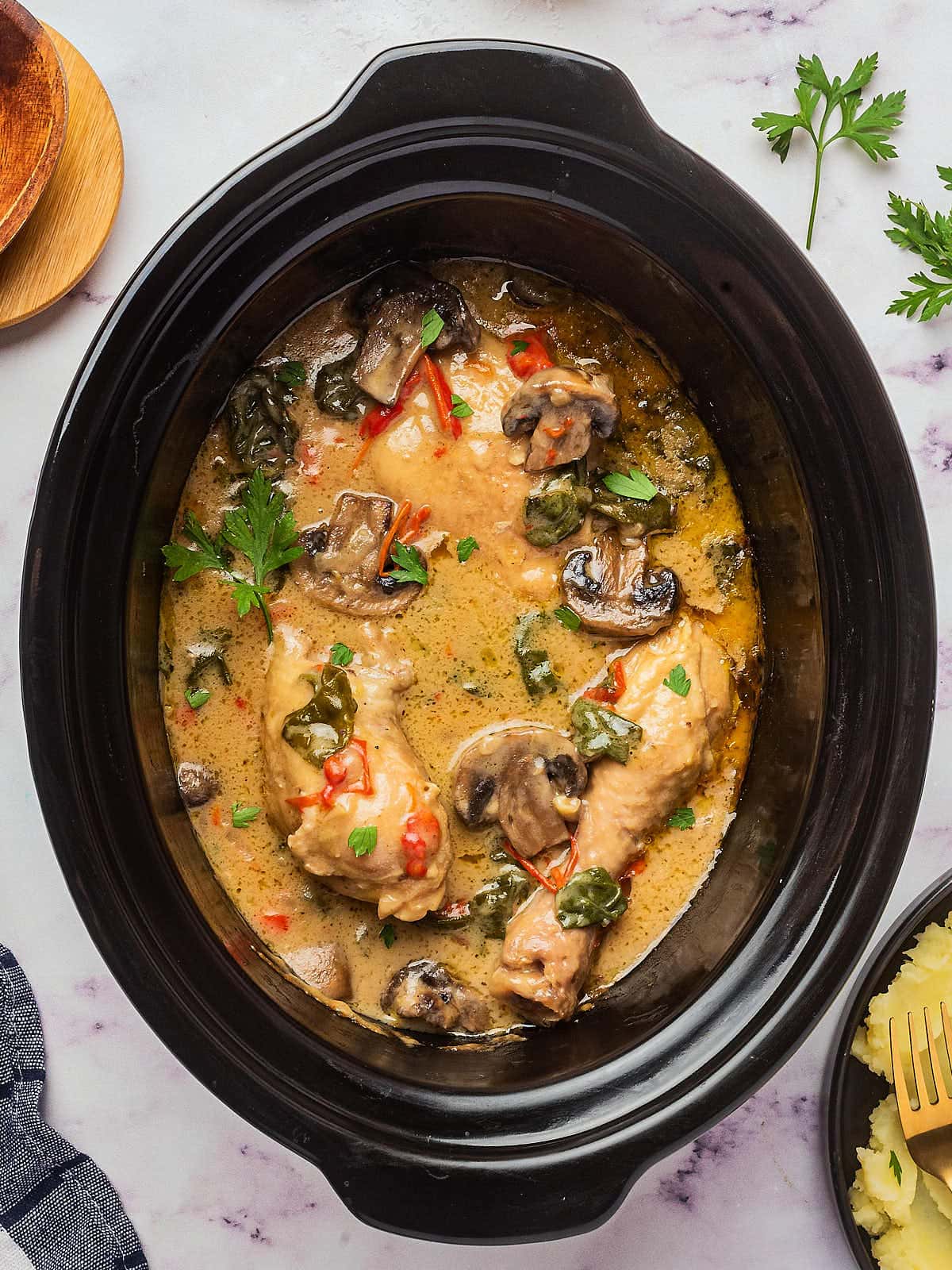 Top-down view of a Crock Pot with Creamy Chicken and Mushrooms. Mushrooms 