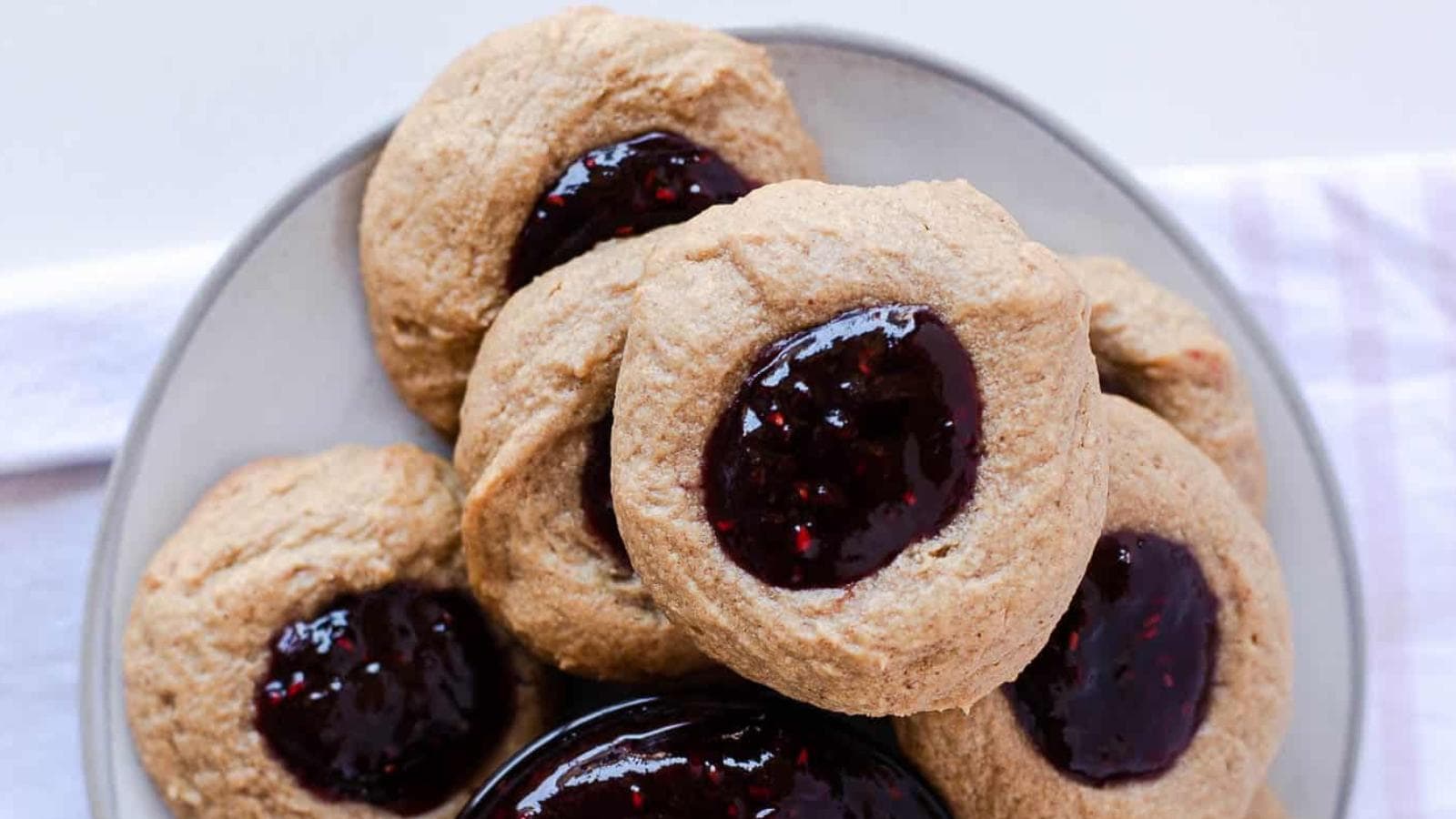 Peanut Butter Thumbprint Cookies With Raspberry Jam recipe by Busy Family Recipes.