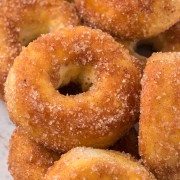 A pile of Air Fryer Donuts rolled in Cinnamon Sugar.